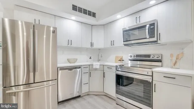 a kitchen with appliances cabinets and a sink