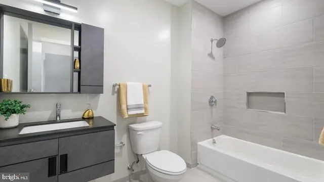 a bathroom with a toilet a sink and bathtub