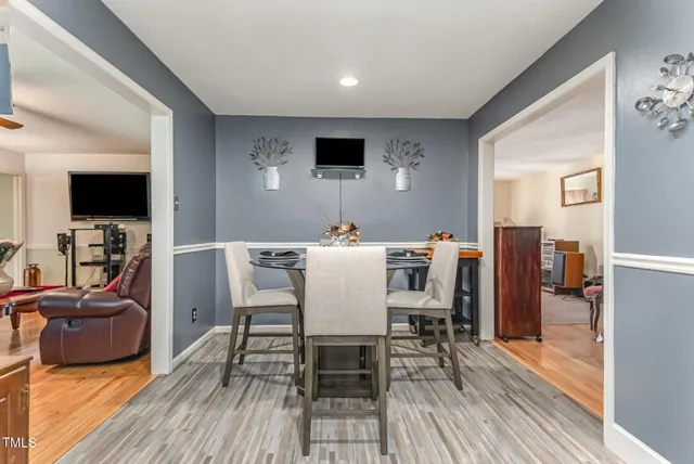 a view of a dining room with furniture and wooden floor