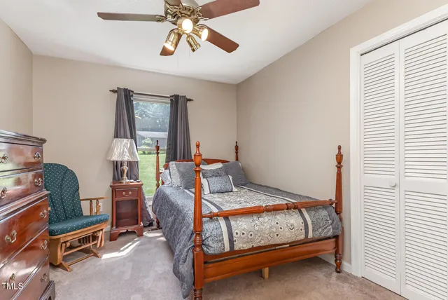 a bedroom with a bed and dresser with mirror
