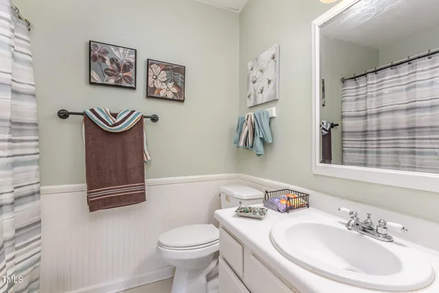 a bedroom with a bed a window and dresser