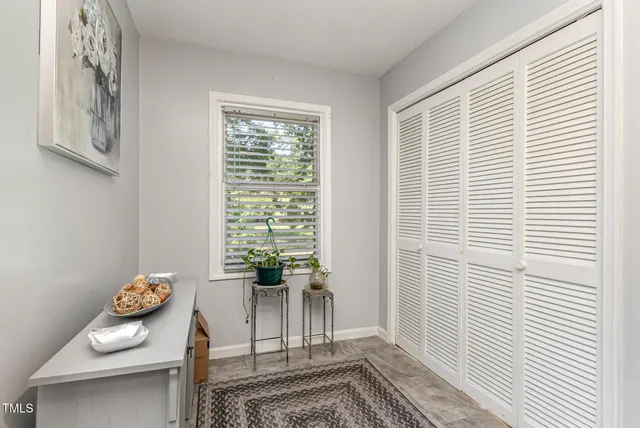 a view of a chairs and table in patio with wooden floor