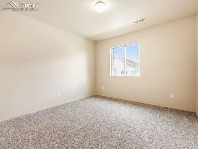 a view of backyard of house with green space