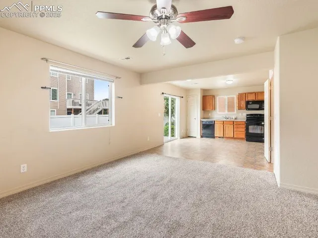 a view of a livingroom with furniture and a kitchen