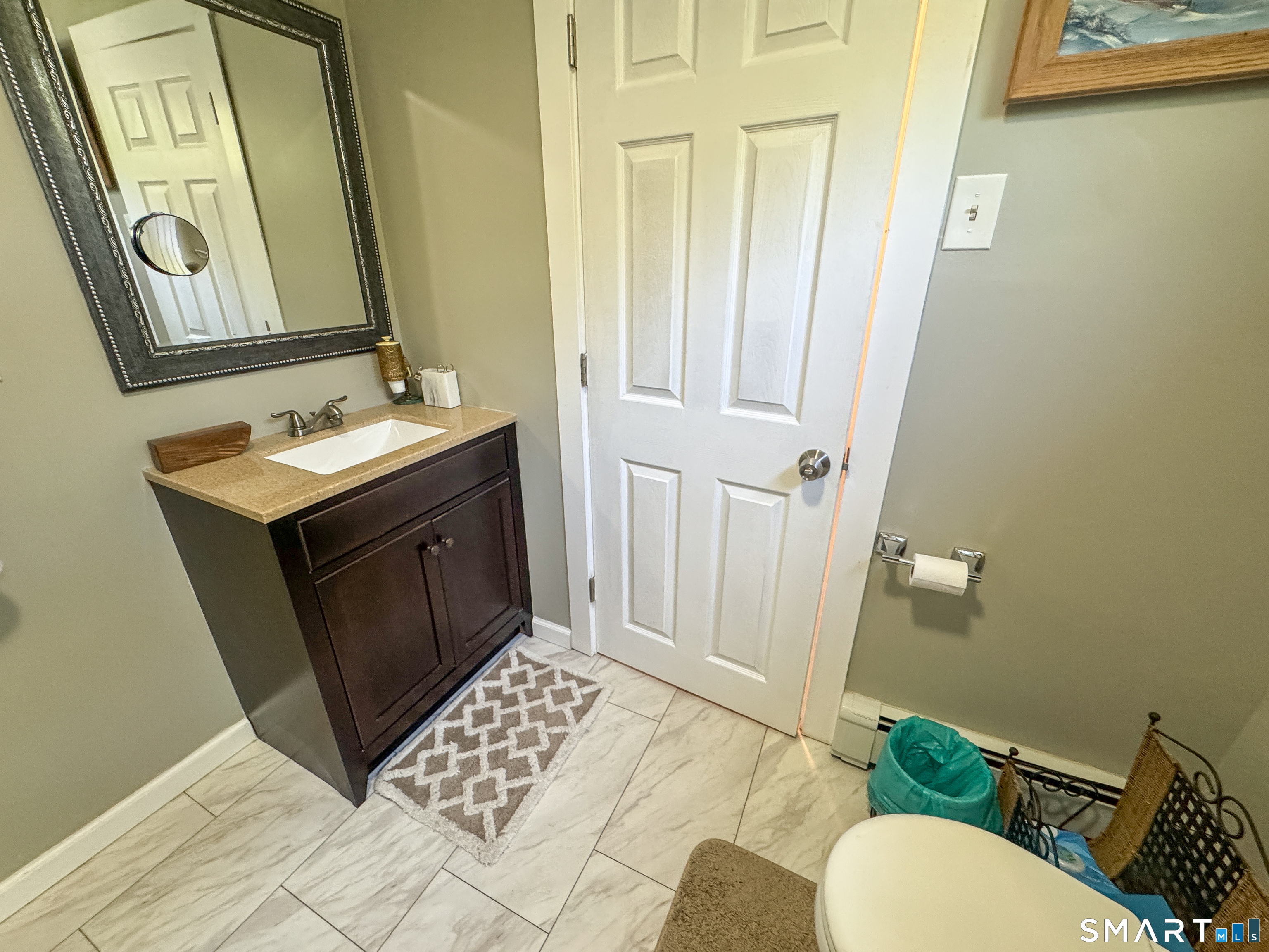 36 Jennings Street Norwich, CT 06360 - Photo 23 of 33 a bathroom with a sink a toilet a mirror and vanity