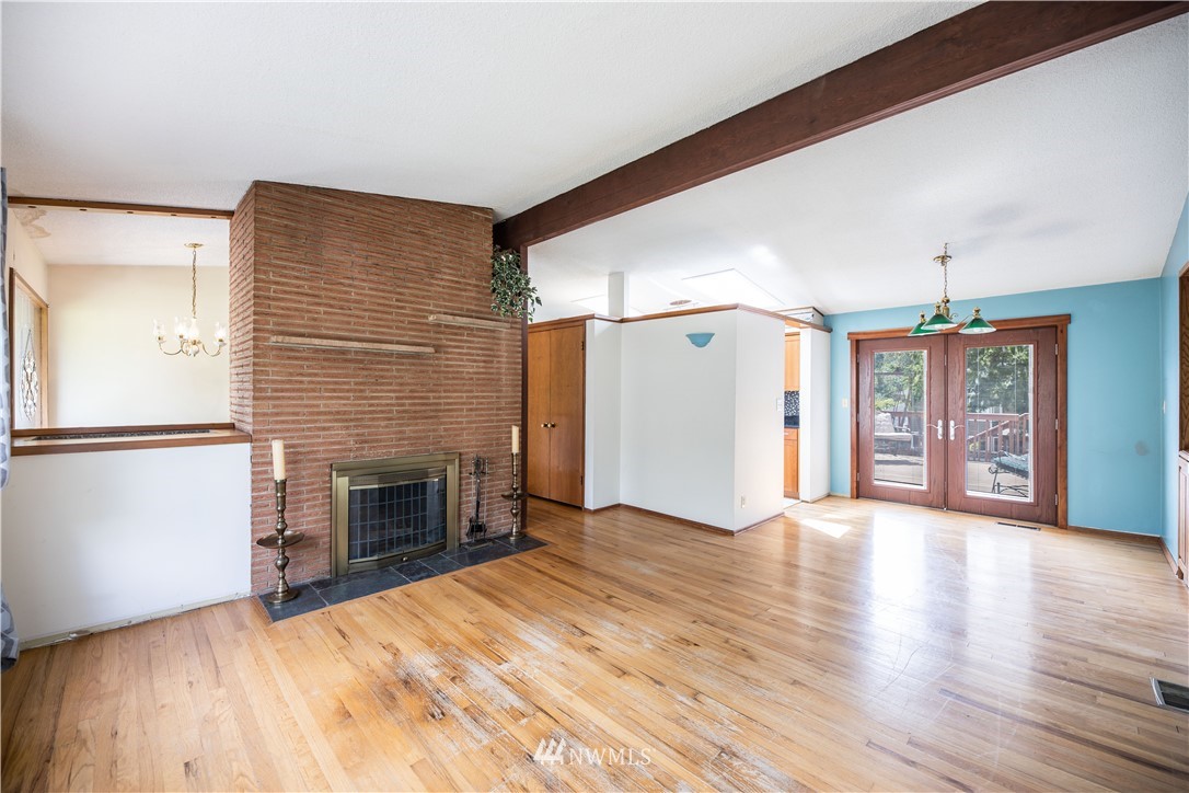23816 Brier Road Brier, WA 98036 - Photo 11 of 39 a view of empty room with wooden floor and fireplace