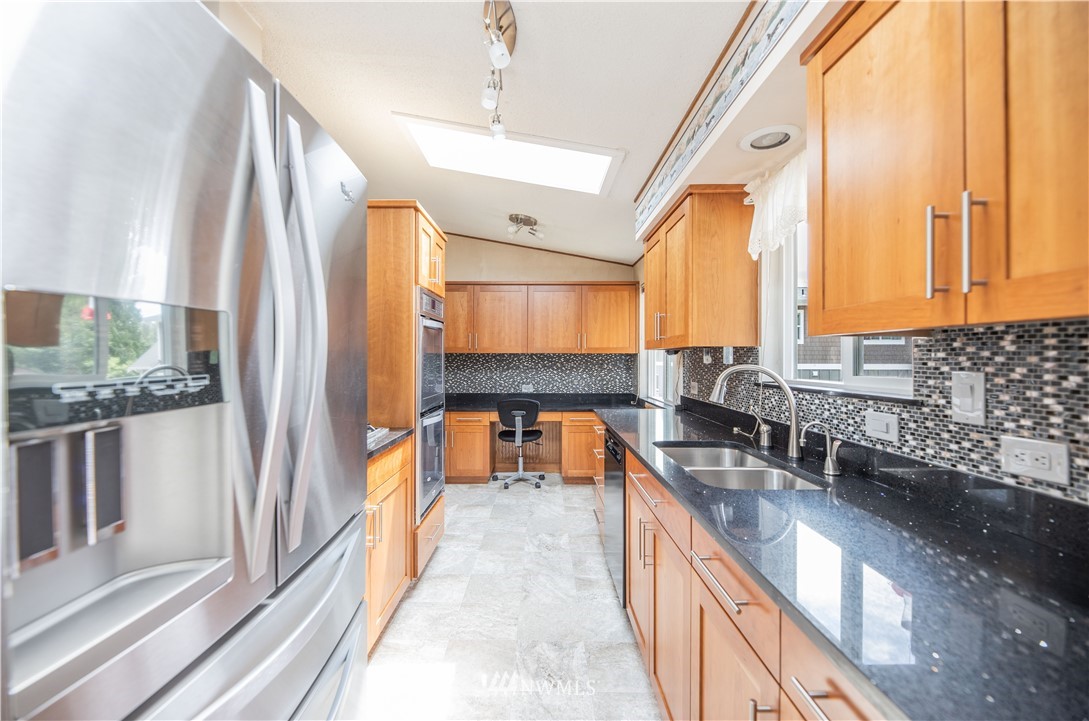23816 Brier Road Brier, WA 98036 - Photo 14 of 39 a kitchen with stainless steel appliances granite countertop a sink and a large window