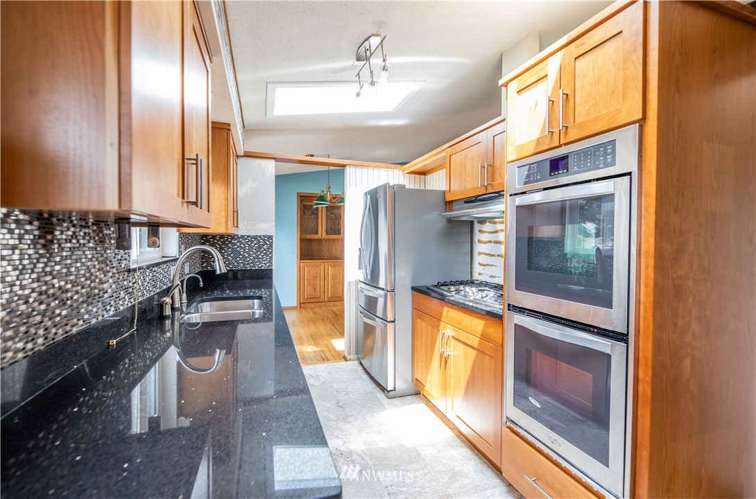 23816 Brier Road Brier, WA 98036 - Photo 17 of 39 a kitchen with stainless steel appliances granite countertop a refrigerator and a stove