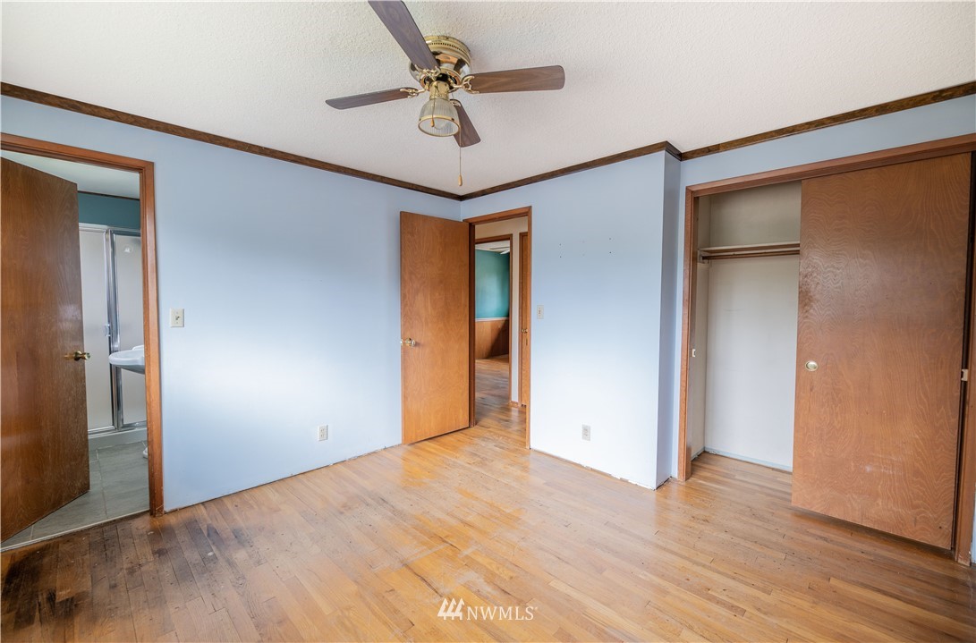 23816 Brier Road Brier, WA 98036 - Photo 18 of 39 a view of a big room with wooden floor and a ceiling fan