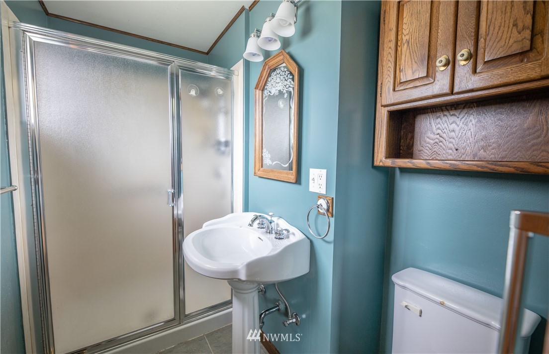 23816 Brier Road Brier, WA 98036 - Photo 23 of 39 a bathroom with a sink a mirror and a toilet