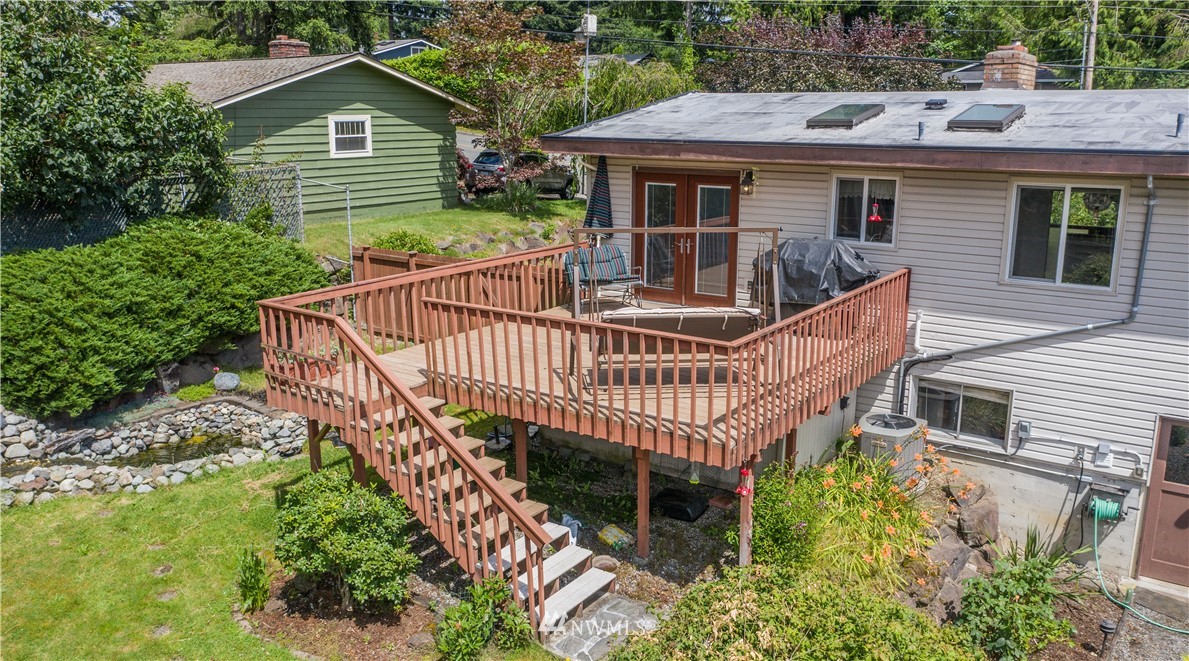23816 Brier Road Brier, WA 98036 - Photo 24 of 39 a view of a house with wooden deck and furniture