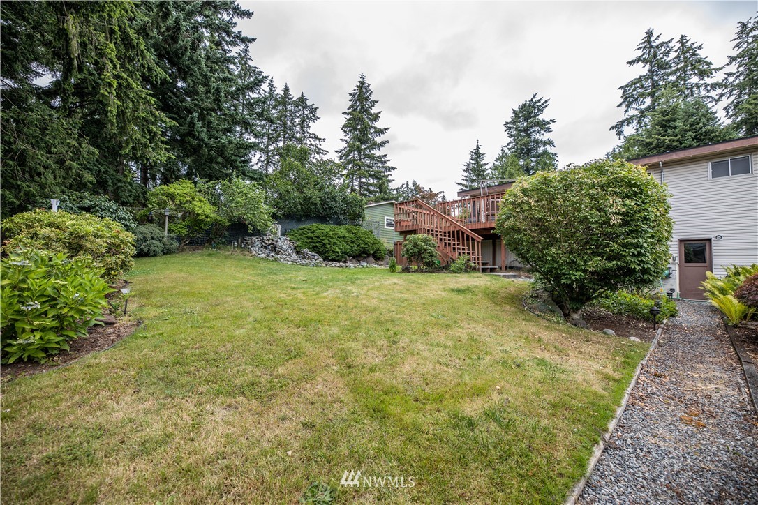23816 Brier Road Brier, WA 98036 - Photo 32 of 39 a view of a backyard with plants and large trees