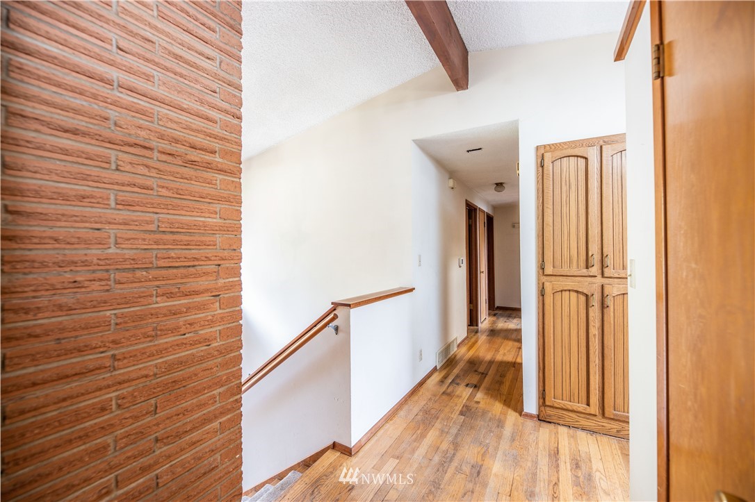23816 Brier Road Brier, WA 98036 - Photo 8 of 39 a view of a hallway with wooden floor and staircase