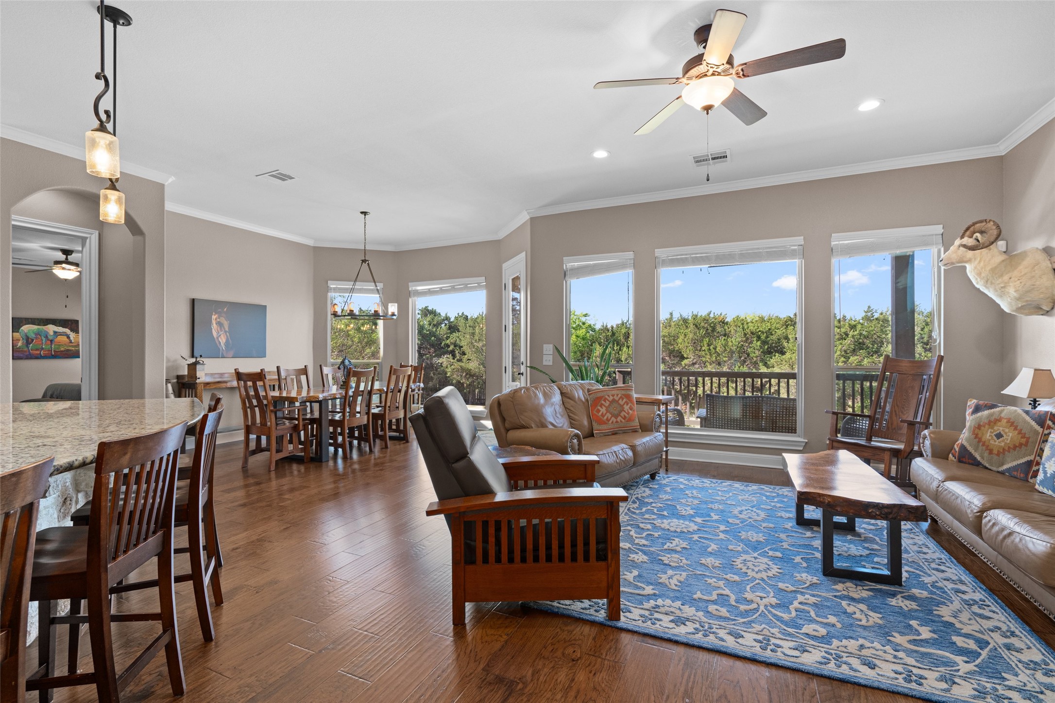 164 Milestone Road Liberty Hill, TX 78642 - Photo 8 of 40 Lots of natural light in this main floor living coming in from the oversized windows.