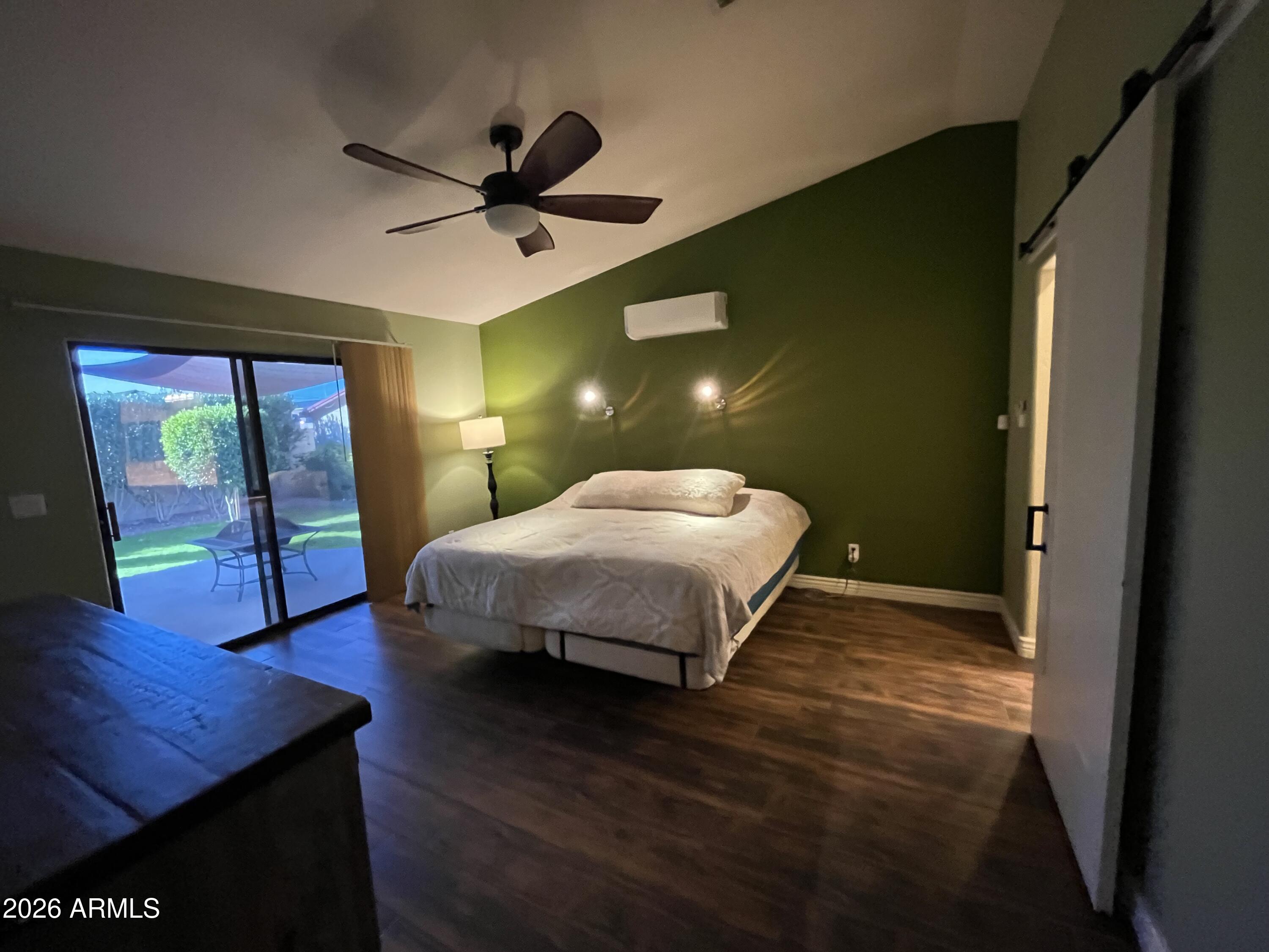 802 East Roberts Road Phoenix, AZ 85022 - Photo 11 of 33 a bedroom with a bed and wooden floor