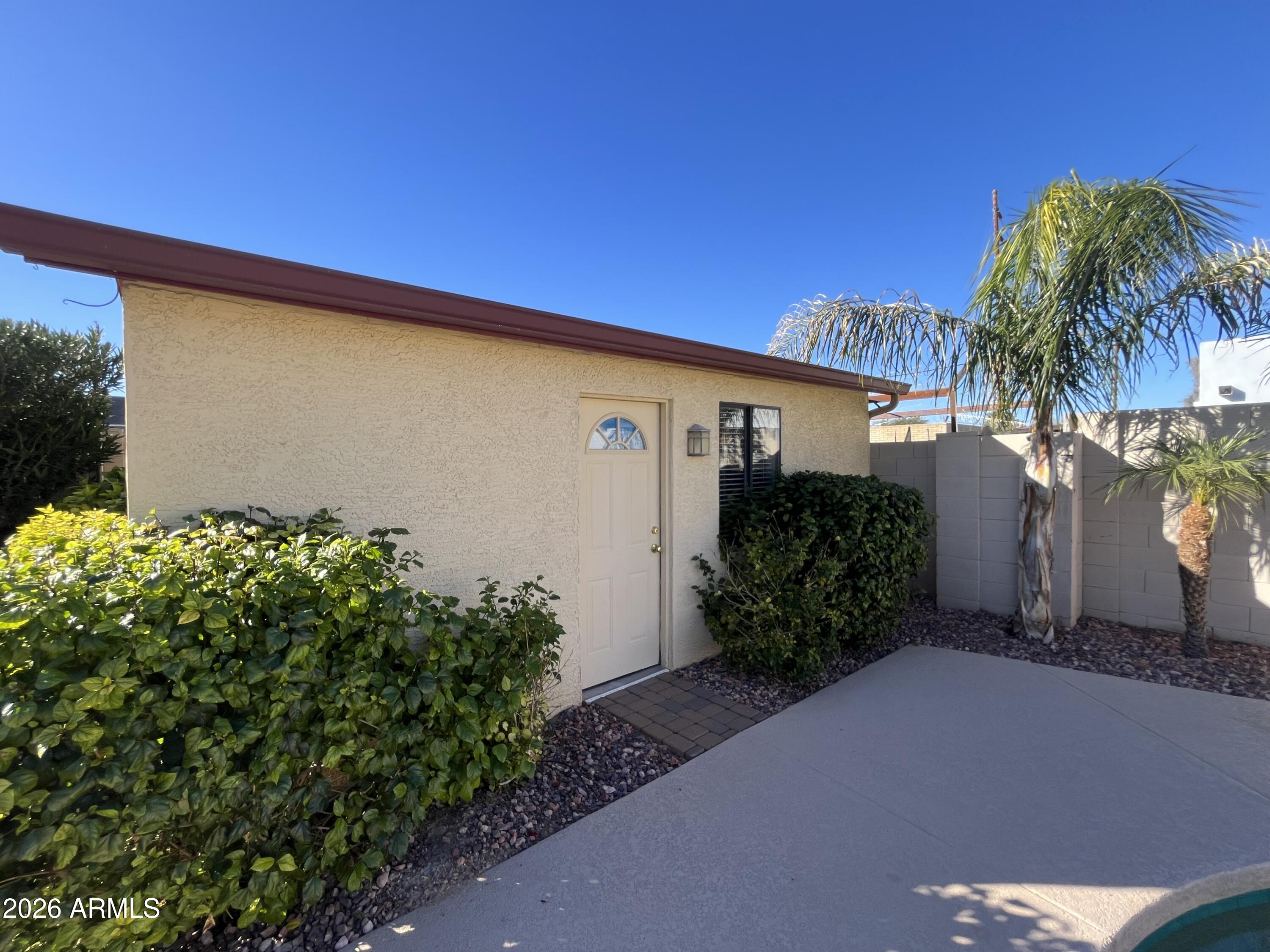 802 East Roberts Road Phoenix, AZ 85022 - Photo 30 of 33 a backyard of a house with potted plants and palm trees