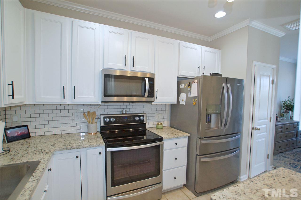 4807 Sir Duncan Way Raleigh, NC 27612 - Photo 13 of 29 a kitchen with stainless steel appliances granite countertop a refrigerator stove and sink
