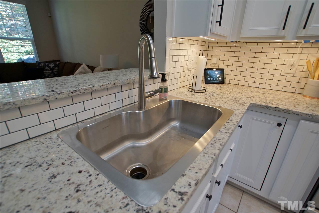 4807 Sir Duncan Way Raleigh, NC 27612 - Photo 15 of 29 a bathroom with a granite countertop sink a mirror and shower