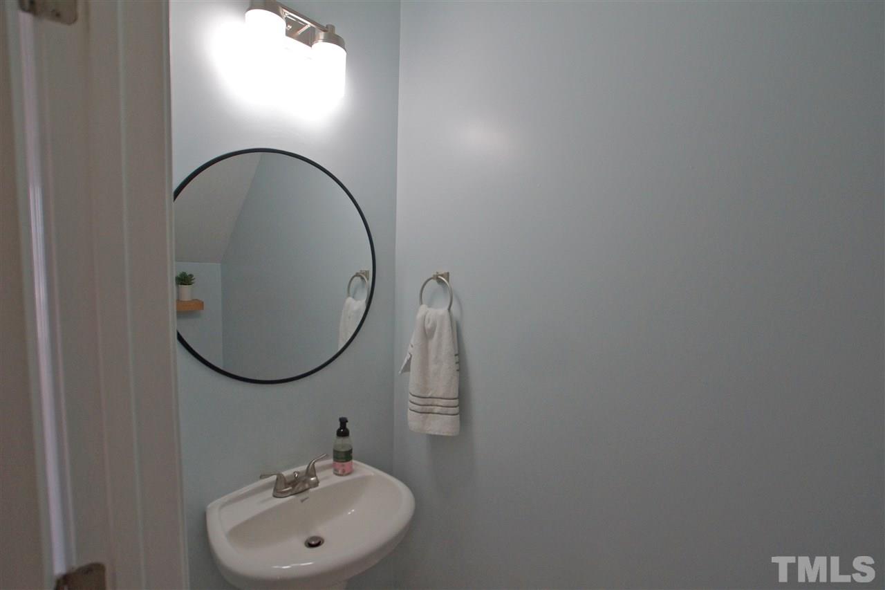 4807 Sir Duncan Way Raleigh, NC 27612 - Photo 18 of 29 a bathroom with a sink and a mirror