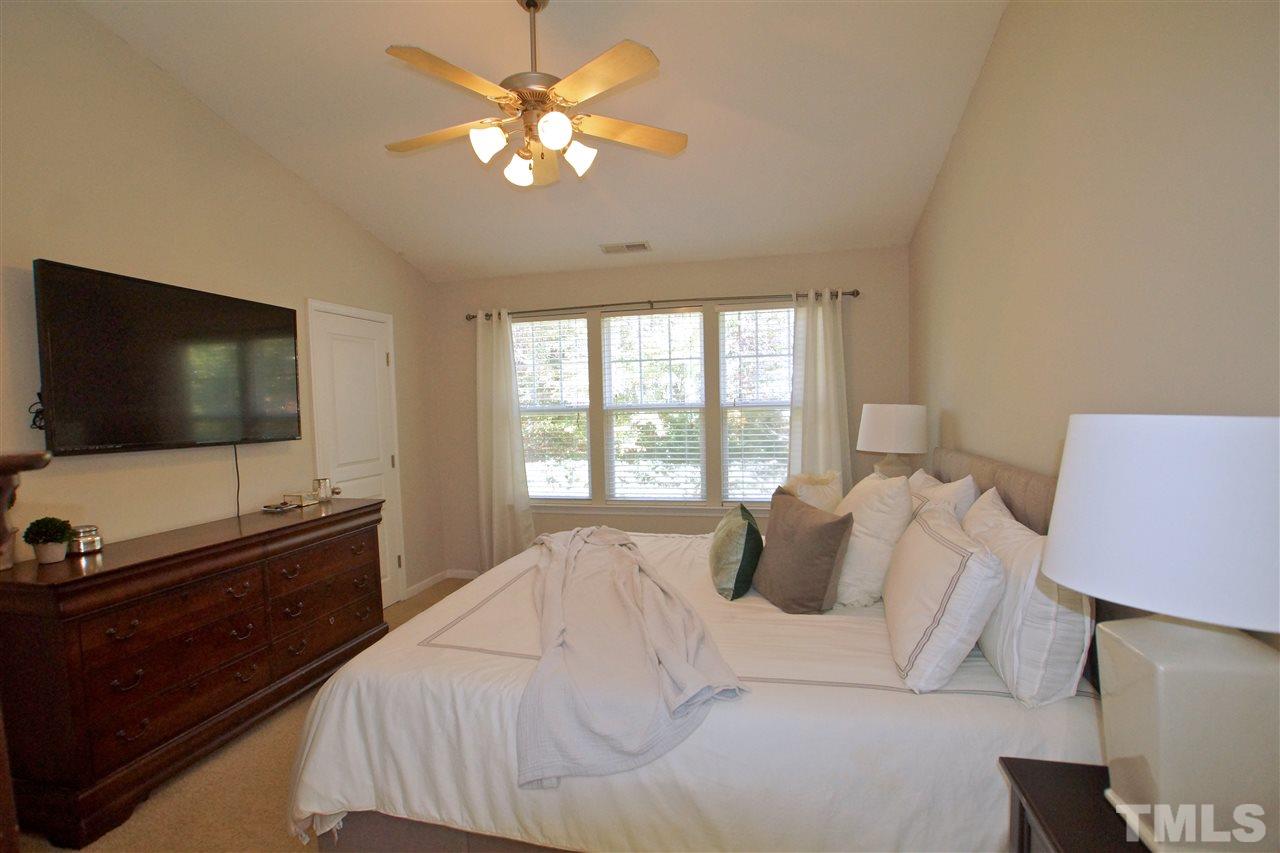 4807 Sir Duncan Way Raleigh, NC 27612 - Photo 22 of 29 a bedroom with a bed and a flat screen tv