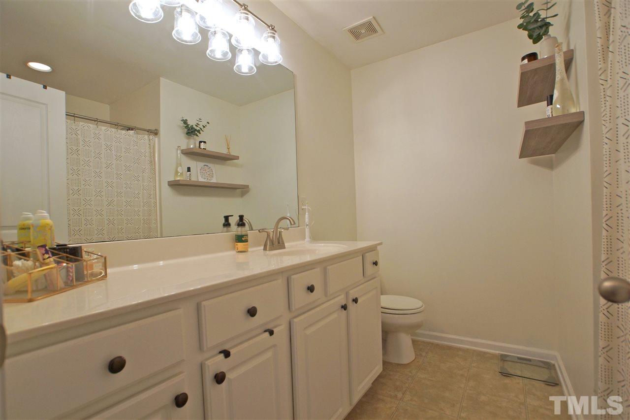 4807 Sir Duncan Way Raleigh, NC 27612 - Photo 23 of 29 a bathroom with a sink a toilet and a mirror