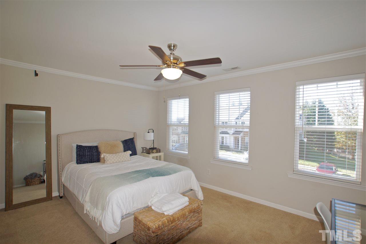 4807 Sir Duncan Way Raleigh, NC 27612 - Photo 24 of 29 a bedroom with a large bed and two windows