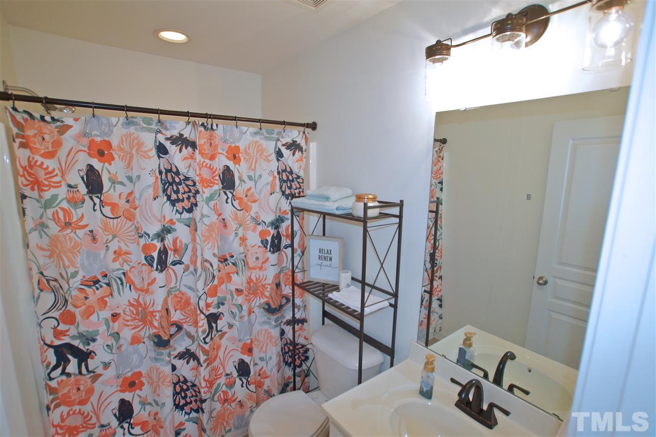 4807 Sir Duncan Way Raleigh, NC 27612 - Photo 26 of 29 a bathroom with a toilet and a shower curtain