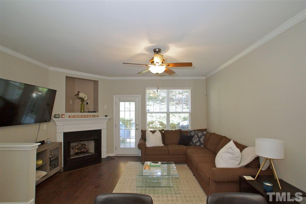 4807 Sir Duncan Way Raleigh, NC 27612 - Photo 7 of 29 a living room with furniture and a fireplace
