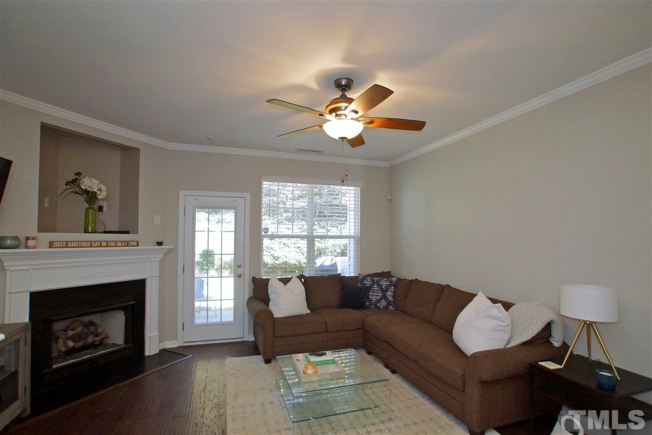 4807 Sir Duncan Way Raleigh, NC 27612 - Photo 8 of 29 a living room with furniture a fireplace and a window