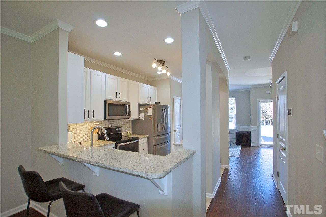 4807 Sir Duncan Way Raleigh, NC 27612 - Photo 10 of 29 a kitchen with cabinets and stainless steel appliances