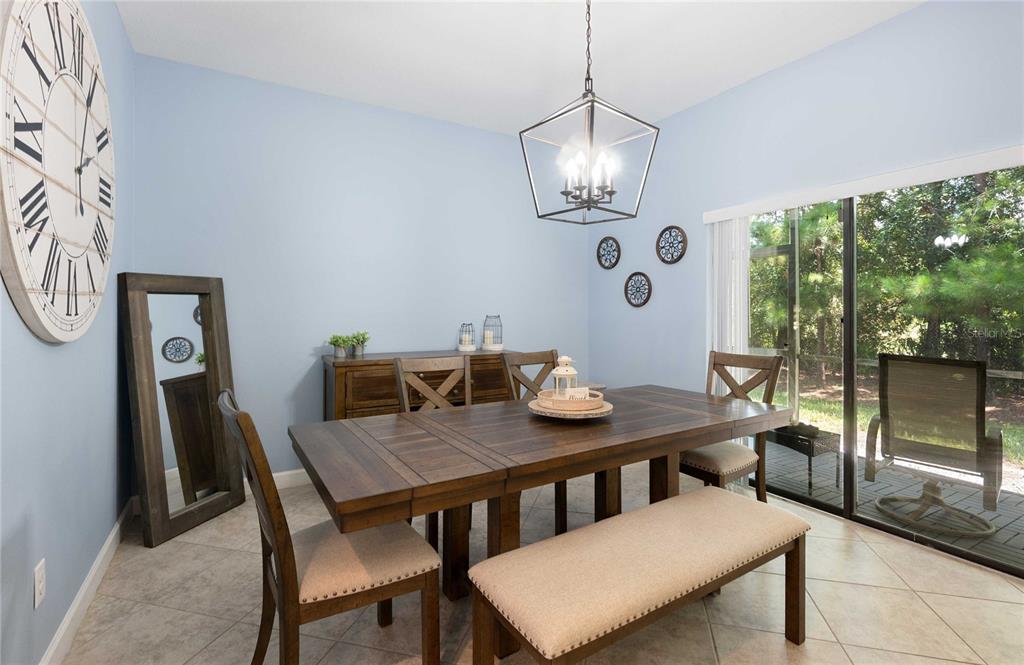 17365 Old Tobacco Road Lutz, FL 33558 - Photo 15 of 44 a view of a dining room with furniture wooden floor and chandelier