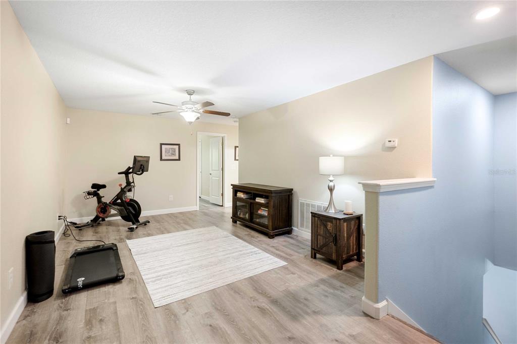 17365 Old Tobacco Road Lutz, FL 33558 - Photo 18 of 44 a living room with furniture a fireplace and a chandelier