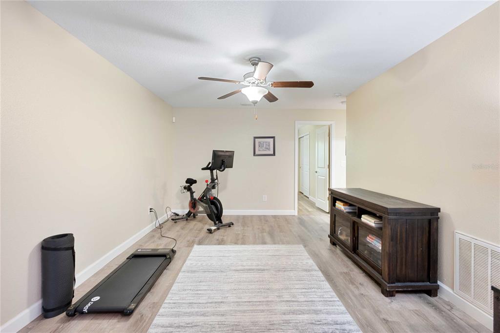 17365 Old Tobacco Road Lutz, FL 33558 - Photo 19 of 44 a view of a room with gym equipment and a ceiling fan