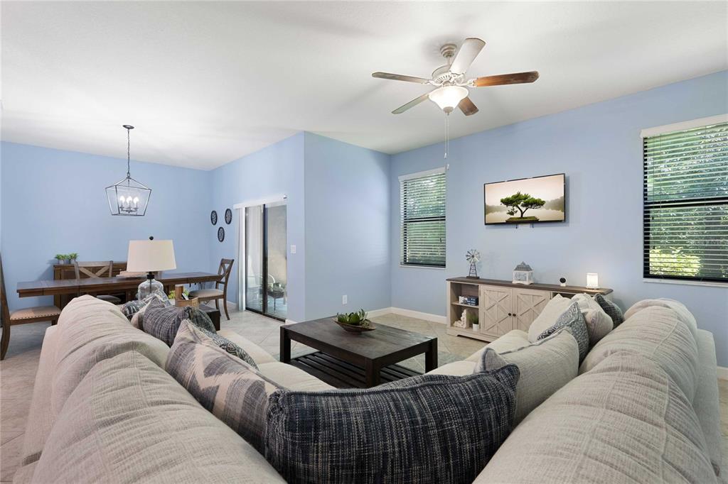 17365 Old Tobacco Road Lutz, FL 33558 - Photo 7 of 44 a living room with furniture a ceiling fan and a window