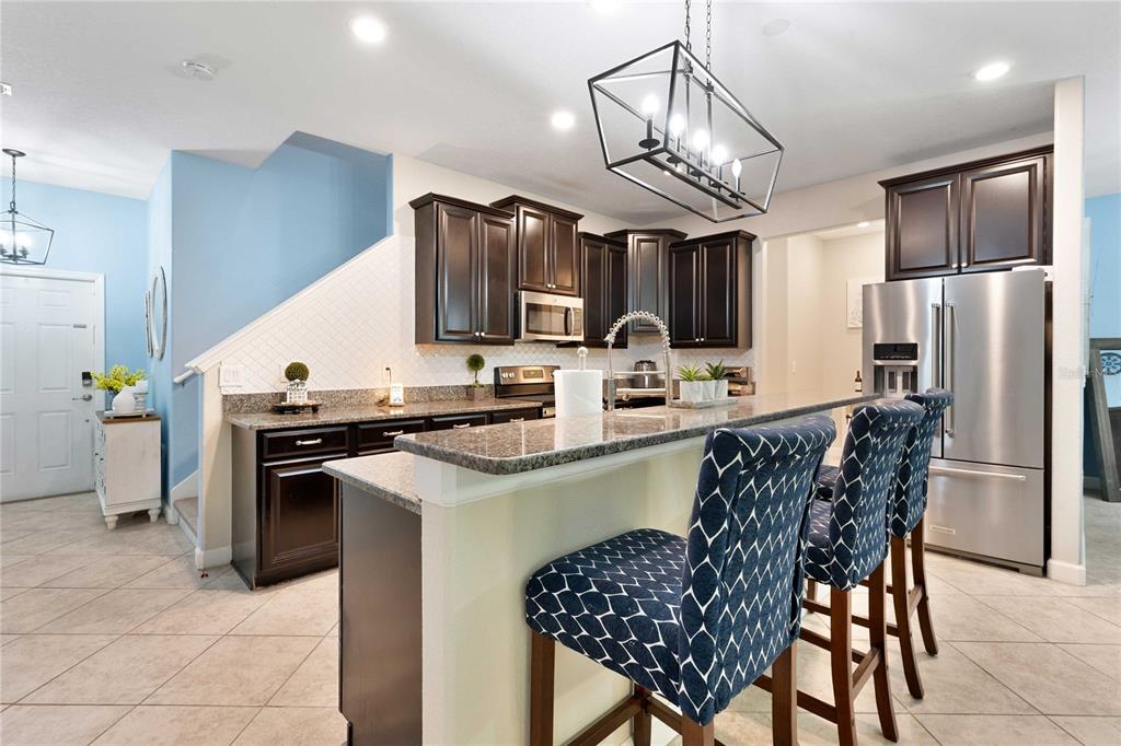17365 Old Tobacco Road Lutz, FL 33558 - Photo 8 of 44 a kitchen with stainless steel appliances a sink a stove a refrigerator cabinets and a dining table