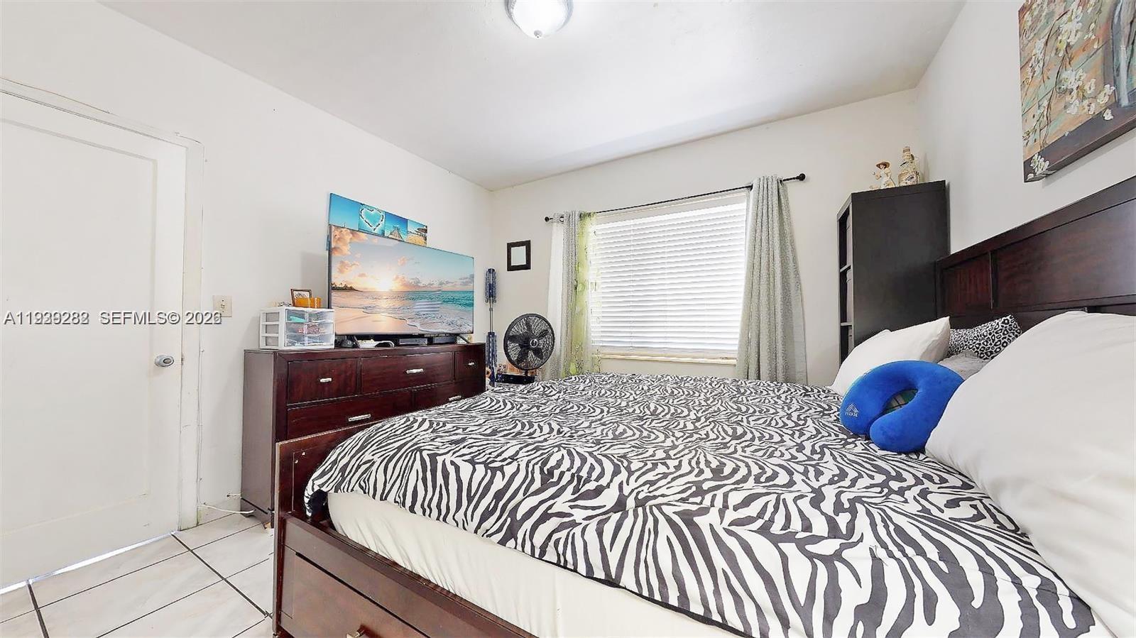 2499 Southwest 27th Street, Unit 1 Miami, FL 33133 - Photo 12 of 14 a bedroom with a bed and a closet