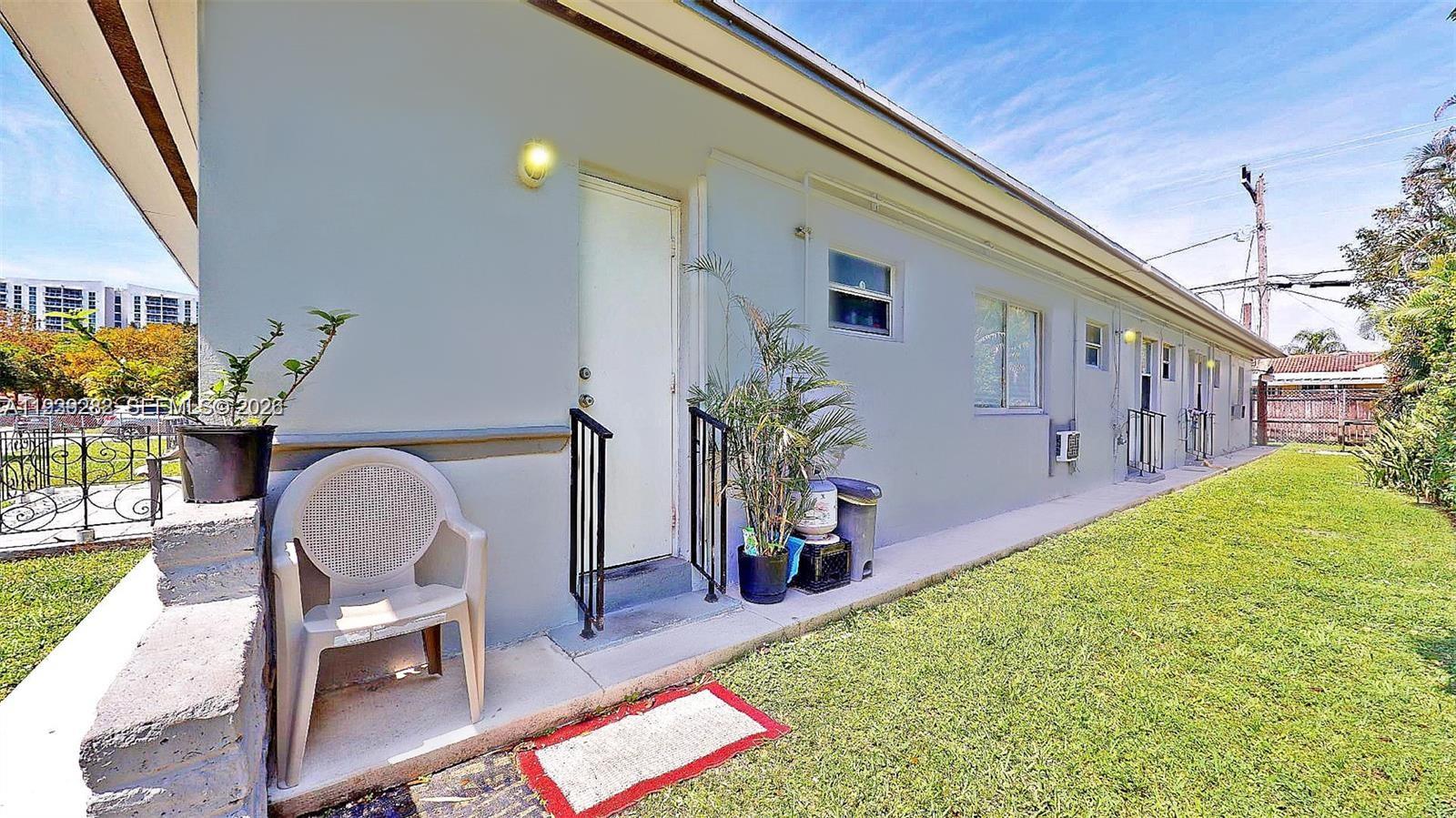 2499 Southwest 27th Street, Unit 1 Miami, FL 33133 - Photo 14 of 14 a backyard of a house with table and chairs