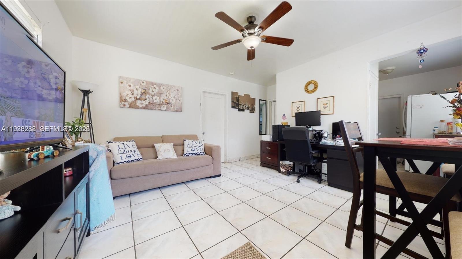 2499 Southwest 27th Street, Unit 1 Miami, FL 33133 - Photo 4 of 14 a living room with furniture and a computer on a desk