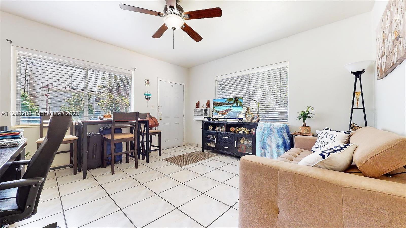 2499 Southwest 27th Street, Unit 1 Miami, FL 33133 - Photo 5 of 14 a living room with furniture and a large window
