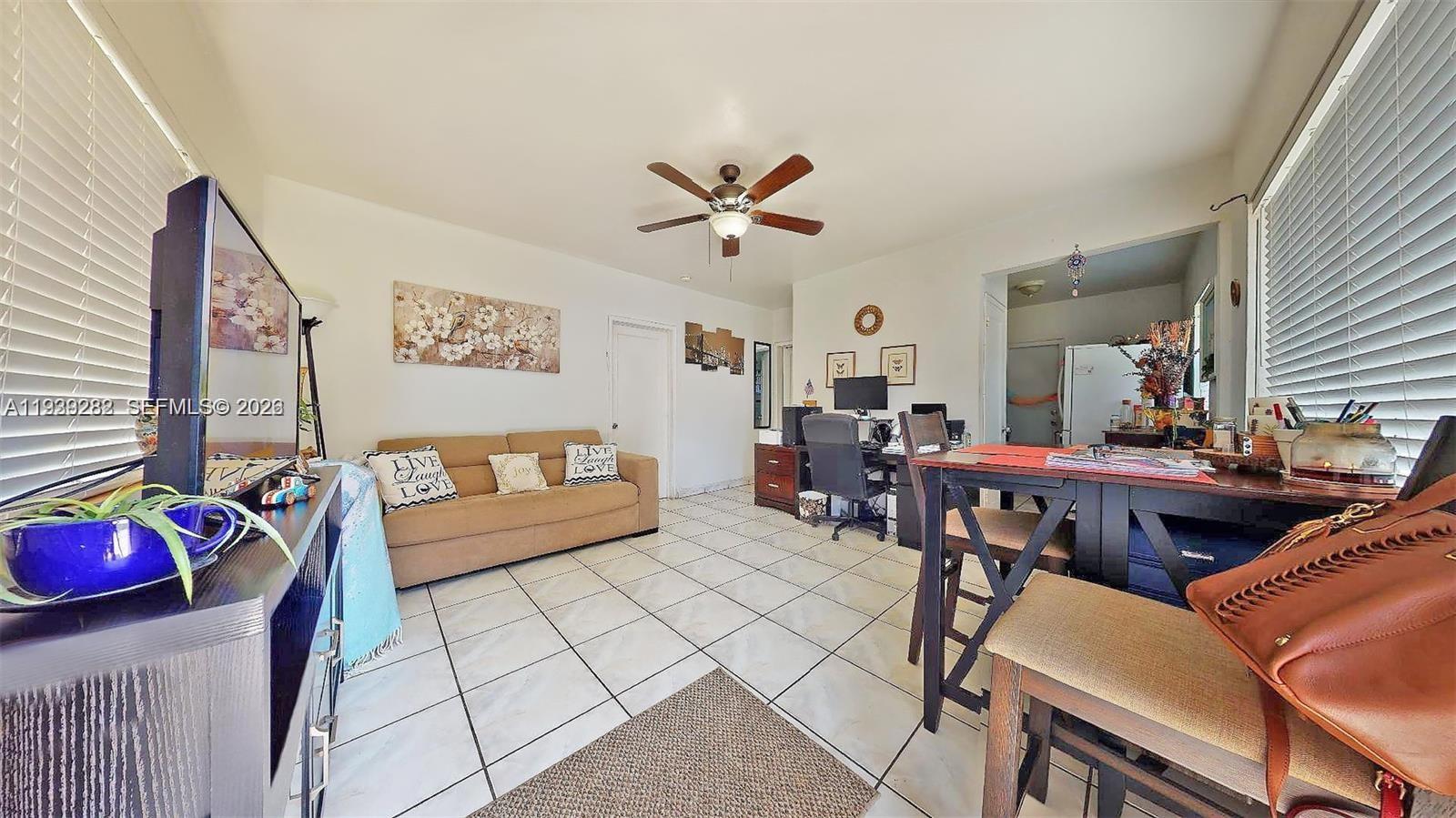 2499 Southwest 27th Street, Unit 1 Miami, FL 33133 - Photo 6 of 14 a living room with furniture and a chandelier