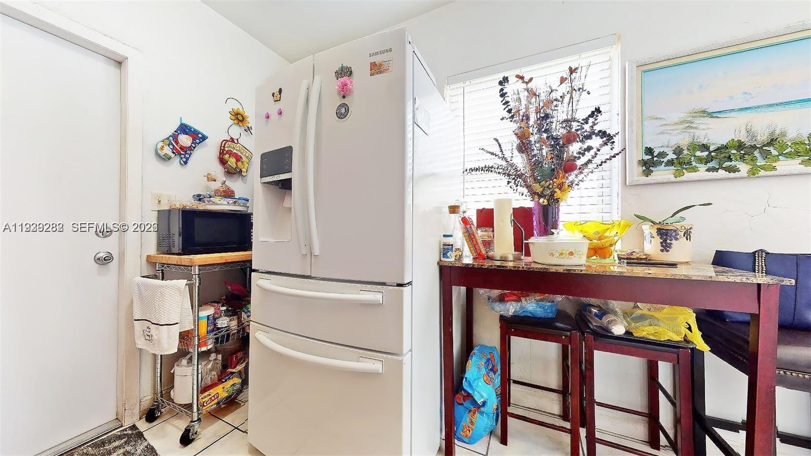 2499 Southwest 27th Street, Unit 1 Miami, FL 33133 - Photo 10 of 14 a view of a room with furniture and wooden floor