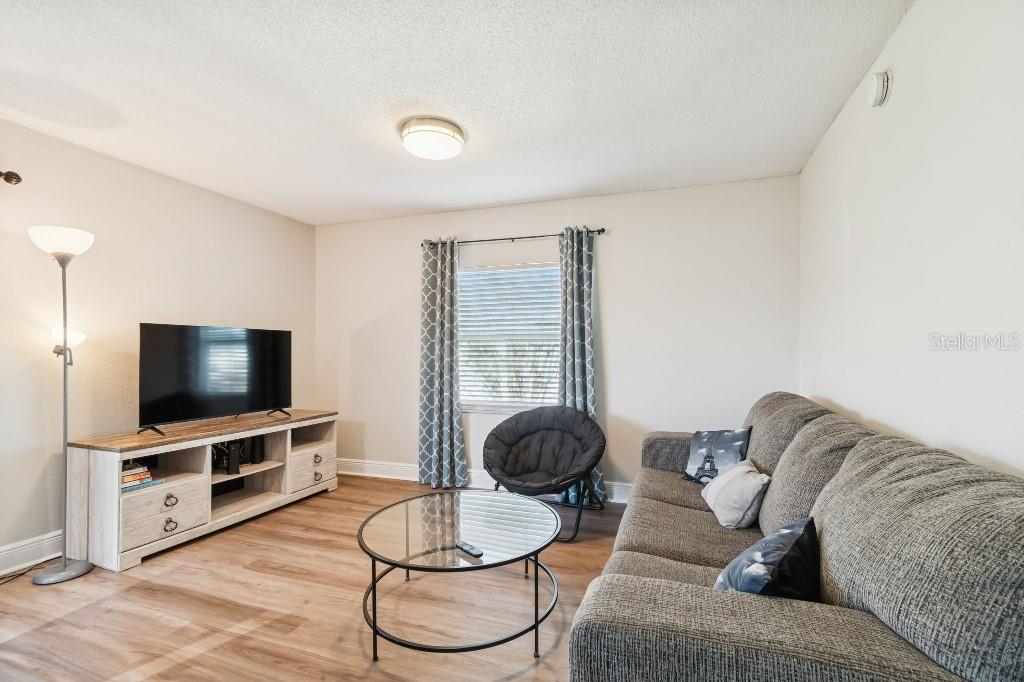 13125 Wilcox Road, Unit 6205 Largo, FL 33774 - Photo 16 of 48 a living room with furniture and a flat screen tv