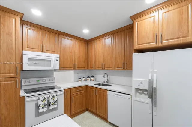 a kitchen with stainless steel appliances granite countertop a refrigerator sink and cabinets