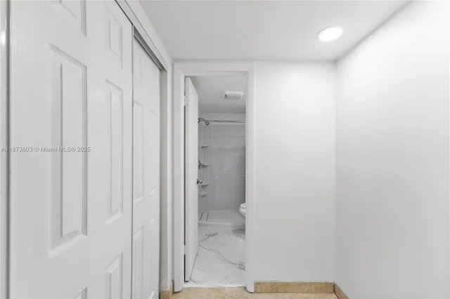 a bathroom with a glass shower door