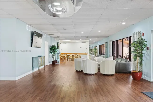 a living room with fireplace furniture and a wooden floor