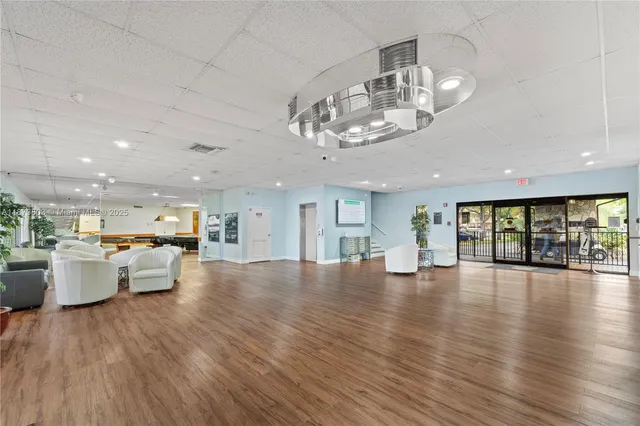 a view of a living room and kitchen with stainless steel appliances