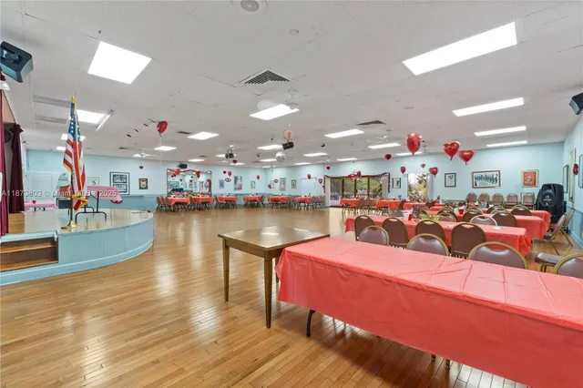 a play room with lots of furniture and wooden floor