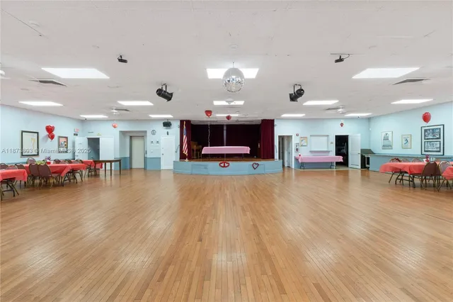 a view of a street with a yard and potted plants