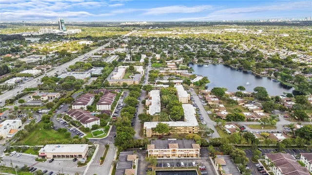 an aerial view of residential houses with outdoor space and swimming pool