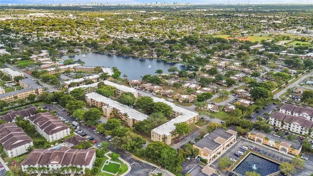 an aerial view of a residential houses with yard